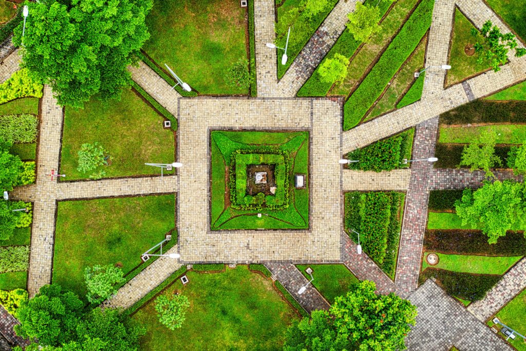 Aerial shot of geometric garden pathways surrounded by lush green flora in Banten, Indonesia.